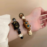 Bracelet mignon petit chat noir pour femmes et hommes, bijou tendance et amusant avec perles, fait main. Idée cadeau pour fille.