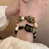 Bracelet mignon petit chat noir pour femmes et hommes, bijou tendance et amusant avec perles, fait main. Idée cadeau pour fille.